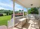 Covered front porch with a cozy seating area overlooking the well-manicured front yard and landscaping at 3697 Travertine Dr, Lancaster, SC 29720