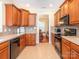 Functional kitchen featuring black appliances, wood cabinets, and tiled backsplash at 3697 Travertine Dr, Lancaster, SC 29720