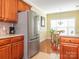 Bright kitchen view, stainless steel refrigerator, and view to the hardwood floor dining area at 3697 Travertine Dr, Lancaster, SC 29720