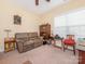 Cozy living room features a comfortable couch and natural light from a window at 3697 Travertine Dr, Lancaster, SC 29720