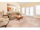 Inviting living room features neutral carpet, comfortable seating, and bright natural light at 3697 Travertine Dr, Lancaster, SC 29720