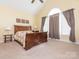 Main bedroom featuring high ceilings, a large window and neutral carpeted floor at 3697 Travertine Dr, Lancaster, SC 29720