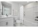 Clean, modern bathroom featuring a vanity with solid surface counters, framed mirror, and tub/shower combination at 416 Balboa St, Matthews, NC 28104