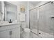 Bright bathroom with a glass shower, marble tile, and a white vanity with a framed mirror at 416 Balboa St, Matthews, NC 28104