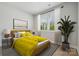 Cozy bedroom with natural light, stylish bedding, and views of the landscaped yard at 416 Balboa St, Matthews, NC 28104
