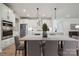 Bright, modern kitchen features white cabinets, stainless steel appliances, and an adjacent dining area at 416 Balboa St, Matthews, NC 28104