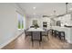 Bright, modern kitchen and breakfast nook features white cabinets, stainless steel appliances, and a large center island with bar seating at 416 Balboa St, Matthews, NC 28104