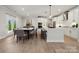 Bright, modern kitchen features white cabinets, stainless steel appliances, and a large center island with bar seating at 416 Balboa St, Matthews, NC 28104