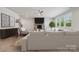 Comfortable living room boasts a brick fireplace, hardwood floors, and bright windows, creating a warm and inviting space at 416 Balboa St, Matthews, NC 28104