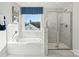Bright bathroom showcasing a soaking tub, separate shower, and stylish marble-like tile surround at 420 Balboa St, Matthews, NC 28104
