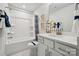 Well-lit bathroom with a combination tub and shower, a spacious vanity, and modern decor at 420 Balboa St, Matthews, NC 28104