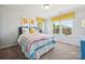 Bright bedroom with a large window, colorful striped bedding, and cheerful decor at 420 Balboa St, Matthews, NC 28104