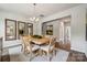 Bright dining room features wood floors, a stylish light fixture, and decorative mirrors at 420 Balboa St, Matthews, NC 28104