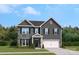 Charming two-story home with stone accents, a two-car garage, and a well-manicured front lawn at 420 Balboa St, Matthews, NC 28104