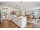 Open kitchen with white cabinets, an island, and seamless transition to the adjacent dining area at 420 Balboa St, Matthews, NC 28104