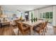 Open-concept living and dining area features a fireplace, a ceiling fan, and backyard access at 420 Balboa St, Matthews, NC 28104