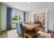 Bright home office with a large window, modern desk, and a view into the hallway at 420 Balboa St, Matthews, NC 28104