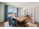 Bright home office with a large window, modern desk, and a view into the hallway at 420 Balboa St, Matthews, NC 28104