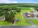 Aerial view of property with surrounding trees and adjacent field and commercial area at 522 Ne Connector Hwy, Albemarle, NC 28001