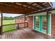 The back deck boasts a wooden floor and railing, offering a cozy spot to relax outdoors at 522 Ne Connector Hwy, Albemarle, NC 28001