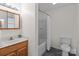 Updated bathroom features vanity with storage, a shower and tub, and a toilet at 522 Ne Connector Hwy, Albemarle, NC 28001