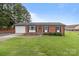 Traditional brick home with attached garage, well-kept lawn, and a welcoming front entrance at 522 Ne Connector Hwy, Albemarle, NC 28001
