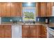 Well-lit kitchen featuring wood cabinetry, granite countertops, and a window with a peaceful outdoor view at 522 Ne Connector Hwy, Albemarle, NC 28001