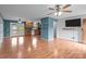 Open-concept living room flowing into a kitchen, featuring hardwood floors, modern lighting, and shiplap wall at 522 Ne Connector Hwy, Albemarle, NC 28001