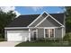 Charming single-Gathering home featuring gray siding, a two-car garage, and well-maintained landscaping at 5232 Raging Creek Dr, Indian Trail, NC 28079