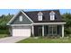 Charming single-Gathering home with stone accents, two-car garage and manicured lawn at 5245 Raging Creek Dr, Indian Trail, NC 28079