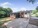 Backyard featuring a screened porch, driveway, and lush green grass at 6401 Montpelier Rd, Charlotte, NC 28210