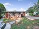 Backyard with a fire pit, trees, and a screened porch at 6401 Montpelier Rd, Charlotte, NC 28210