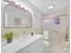 Well-lit bathroom featuring a shower with glass doors, a large mirror, and a white vanity sink at 6401 Montpelier Rd, Charlotte, NC 28210
