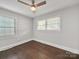 Bright bedroom with hardwood floors, two windows, neutral walls and ceiling fan at 6401 Montpelier Rd, Charlotte, NC 28210