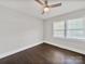 Empty bedroom featuring hardwood floors, ceiling fan, and dual windows offering plenty of light at 6401 Montpelier Rd, Charlotte, NC 28210