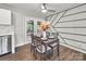 An open dining room area has a table with seating for four and an outdoor deck view through the doors at 6401 Montpelier Rd, Charlotte, NC 28210