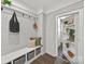 Entryway features a bench with storage and hooks with a doorway leading to shelving and the kitchen at 6401 Montpelier Rd, Charlotte, NC 28210