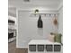 Entryway with a bench and storage, hooks, and a decorative brick wall leading into the kitchen at 6401 Montpelier Rd, Charlotte, NC 28210