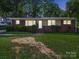 Charming brick home with a well-maintained lawn, showcasing the property's curb appeal and welcoming facade at 6401 Montpelier Rd, Charlotte, NC 28210