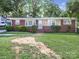 Charming brick home with manicured lawn and quaint front entryway at 6401 Montpelier Rd, Charlotte, NC 28210