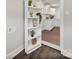 Hallway view to kitchen with shelving for decor and plants, and modern white cabinets at 6401 Montpelier Rd, Charlotte, NC 28210