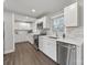 Bright kitchen features stainless steel appliances, white cabinets, and subway tile backsplash at 6401 Montpelier Rd, Charlotte, NC 28210