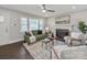 Bright living room featuring a decorative fireplace, ceiling fan, and hardwood floors at 6401 Montpelier Rd, Charlotte, NC 28210