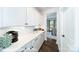 Butler's pantry features white cabinets, quartz countertop, and stainless steel appliances at 7030 Butternut Oak Ter, Huntersville, NC 28078