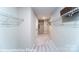 Walk-in closet offering ample storage space with wire shelving and neutral carpeting at 7030 Butternut Oak Ter, Huntersville, NC 28078