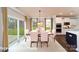 Bright dining room with a view of the backyard, seating for six, and an adjacent modern kitchen at 7030 Butternut Oak Ter, Huntersville, NC 28078