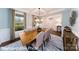 Dining room with table set for six, large windows, and decorative wall hangings at 7030 Butternut Oak Ter, Huntersville, NC 28078