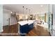 Modern kitchen with large island, seating and stainless steel appliances opens to breakfast area at 7030 Butternut Oak Ter, Huntersville, NC 28078