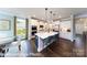 Gourmet kitchen with large island, stainless steel appliances and sleek white cabinetry at 7030 Butternut Oak Ter, Huntersville, NC 28078