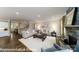 Spacious living room with a fireplace, hardwood floors, staircase, and an open floor plan at 7030 Butternut Oak Ter, Huntersville, NC 28078